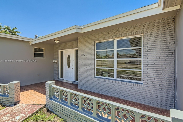 3226 NW 41st St, Lauderdale Lakes, FL 33309 - view of exterior entry featuring brick siding