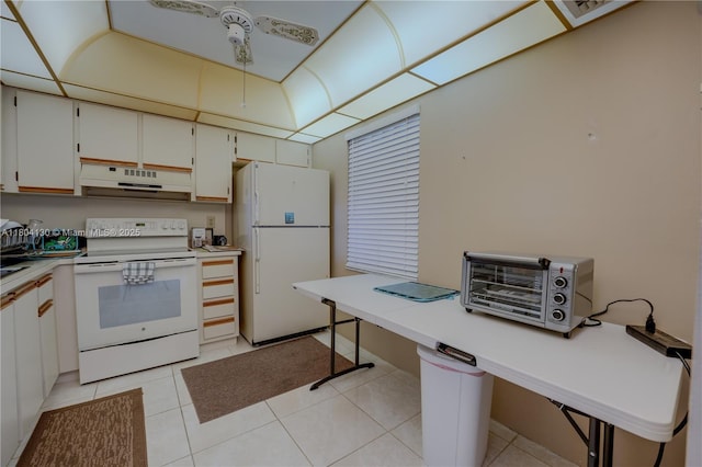 170 SE 5th Ave Unit 505, Dania Beach, FL 33004 - kitchen featuring white appliances, under cabinet range hood, light countertops, and light tile patterned flooring