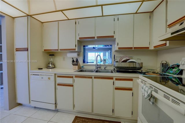 170 SE 5th Ave Unit 505, Dania Beach, FL 33004 - kitchen with white appliances, a sink, light countertops, light tile patterned floors, and exhaust hood