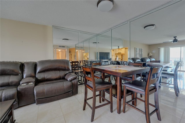 170 SE 5th Ave Unit 505, Dania Beach, FL 33004 - dining room featuring light tile patterned floors, a textured ceiling, and ceiling fan