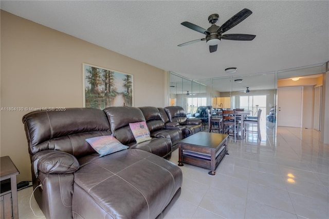 170 SE 5th Ave Unit 505, Dania Beach, FL 33004 - living room featuring ceiling fan, light tile patterned floors, and a textured ceiling