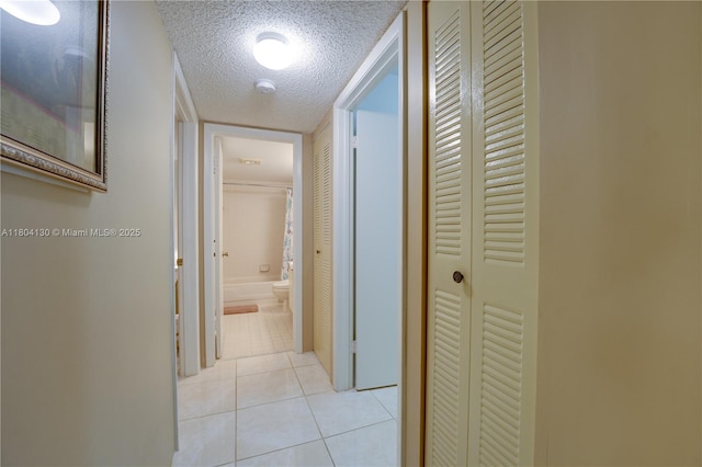 170 SE 5th Ave Unit 505, Dania Beach, FL 33004 - hallway with a textured ceiling and light tile patterned floors
