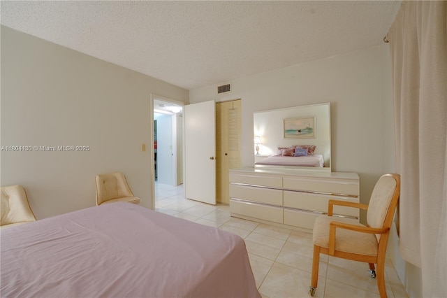 170 SE 5th Ave Unit 505, Dania Beach, FL 33004 - bedroom with light tile patterned floors, a closet, and a textured ceiling