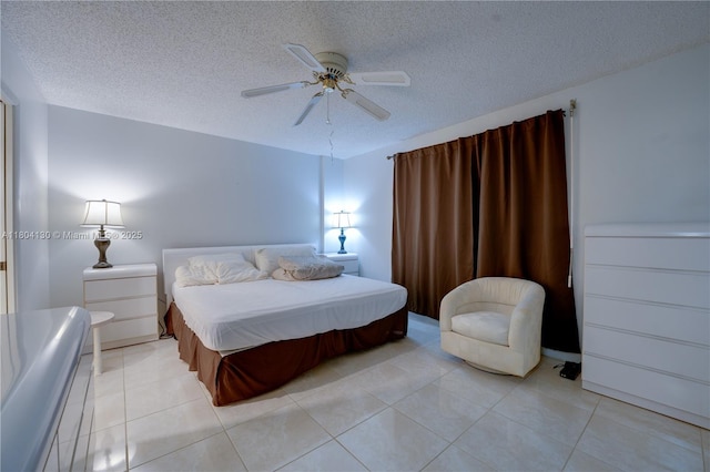 170 SE 5th Ave Unit 505, Dania Beach, FL 33004 - bedroom featuring a textured ceiling, light tile patterned flooring, and a ceiling fan