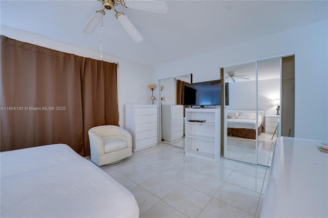 170 SE 5th Ave Unit 505, Dania Beach, FL 33004 - bedroom with tile patterned flooring, ceiling fan, and a textured ceiling