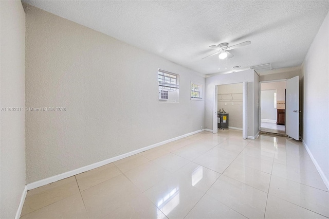 4240 NW 22nd St, Lauderhill, FL 33313 - empty room featuring a textured ceiling, ceiling fan, light tile patterned floors, and baseboards
