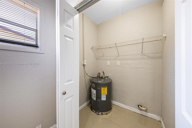 4240 NW 22nd St, Lauderhill, FL 33313 - unfurnished bedroom featuring a textured ceiling, a closet, light tile patterned floors, a ceiling fan, and baseboards