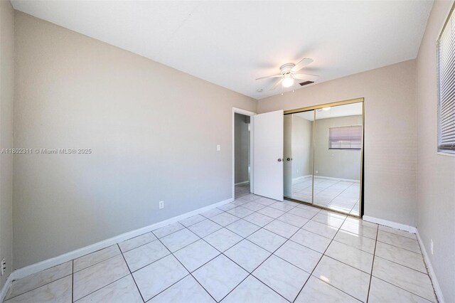 4240 NW 22nd St, Lauderhill, FL 33313 - unfurnished bedroom with a closet, ceiling fan, light tile patterned floors, and baseboards