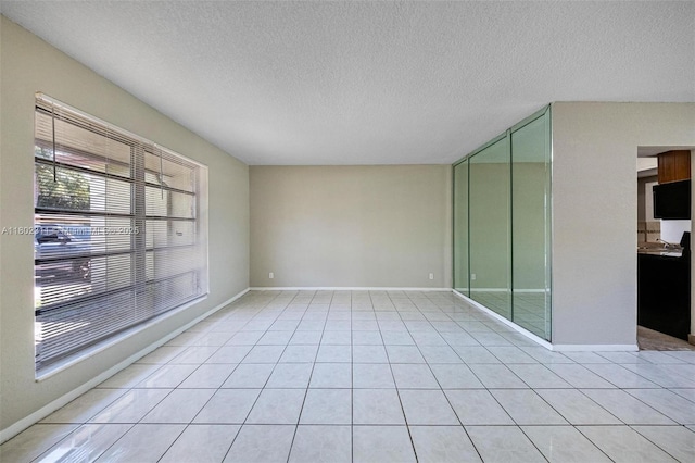 4240 NW 22nd St, Lauderhill, FL 33313 - empty room with a textured ceiling, baseboards, and light tile patterned floors