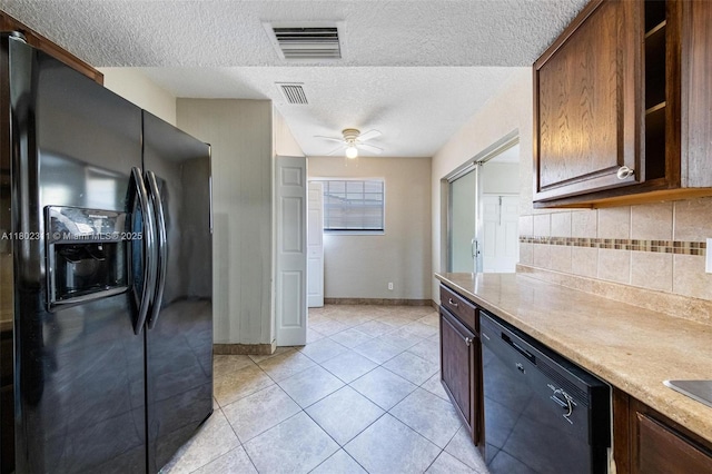4240 NW 22nd St, Lauderhill, FL 33313 - kitchen with black appliances, backsplash, a textured ceiling, light countertops, and light tile patterned floors