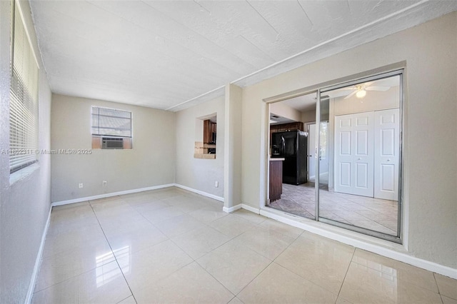 4240 NW 22nd St, Lauderhill, FL 33313 - tiled empty room featuring plenty of natural light, baseboards, cooling unit, and a ceiling fan