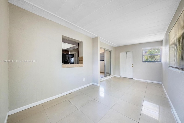 4240 NW 22nd St, Lauderhill, FL 33313 - tiled spare room featuring baseboards