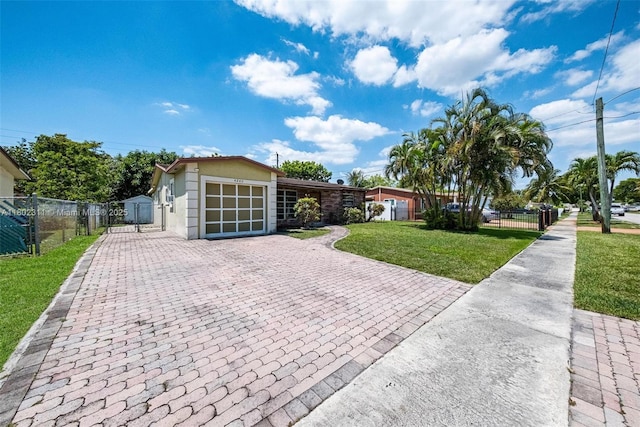 4240 NW 22nd St, Lauderhill, FL 33313 - view of front facade featuring decorative driveway, stucco siding, and an attached garage