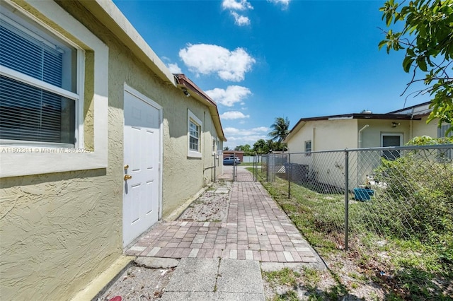 4240 NW 22nd St, Lauderhill, FL 33313 - view of home's exterior with stucco siding and a gate