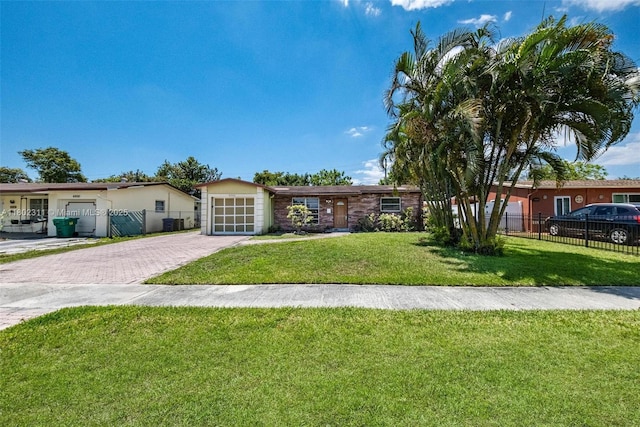 4240 NW 22nd St, Lauderhill, FL 33313 - single story home featuring decorative driveway, a garage, and stucco siding