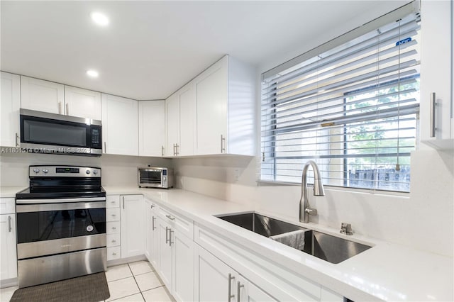 8693 SW 137th Ave Unit 8693, Miami, FL 33183 - kitchen with appliances with stainless steel finishes, a sink, white cabinets, light countertops, and recessed lighting