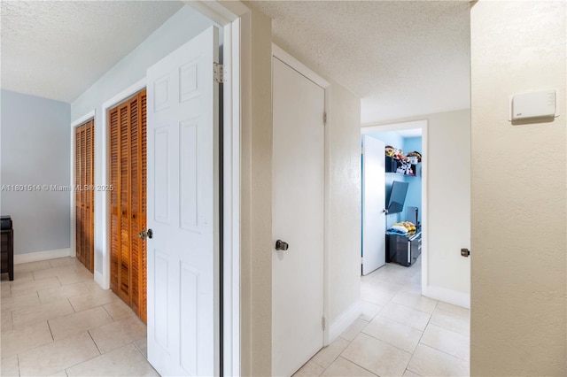8693 SW 137th Ave Unit 8693, Miami, FL 33183 - hallway with a textured ceiling and light tile patterned floors