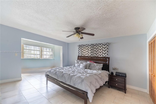 8693 SW 137th Ave Unit 8693, Miami, FL 33183 - tiled bedroom featuring a ceiling fan and a textured ceiling