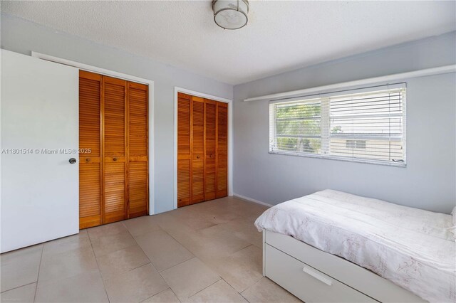 8693 SW 137th Ave Unit 8693, Miami, FL 33183 - bedroom featuring multiple closets and a textured ceiling