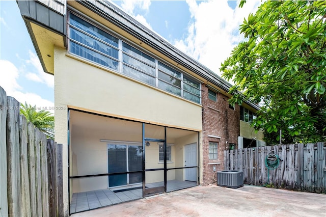 8693 SW 137th Ave Unit 8693, Miami, FL 33183 - back of house with cooling unit, fence, a patio, stucco siding, and brick siding