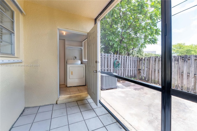 8693 SW 137th Ave Unit 8693, Miami, FL 33183 - entryway featuring washer / dryer, a textured wall, and tile patterned flooring