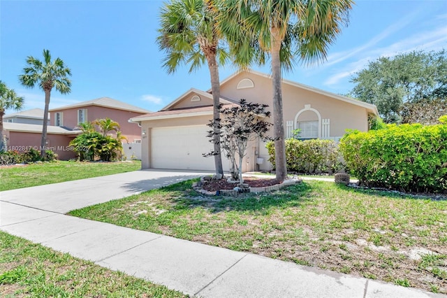 6077 Azalea Cir, West Palm Beach, FL 33415 - view of front of house featuring stucco siding, an attached garage, driveway, and a front yard
