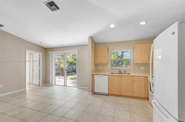 6077 Azalea Cir, West Palm Beach, FL 33415 - kitchen featuring white appliances, light brown cabinetry, a sink, light countertops, and plenty of natural light
