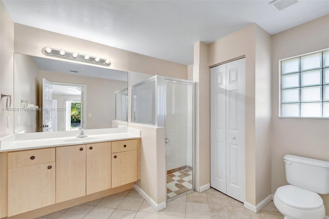 6077 Azalea Cir, West Palm Beach, FL 33415 - bathroom with a closet, a shower stall, vanity, baseboards, and toilet