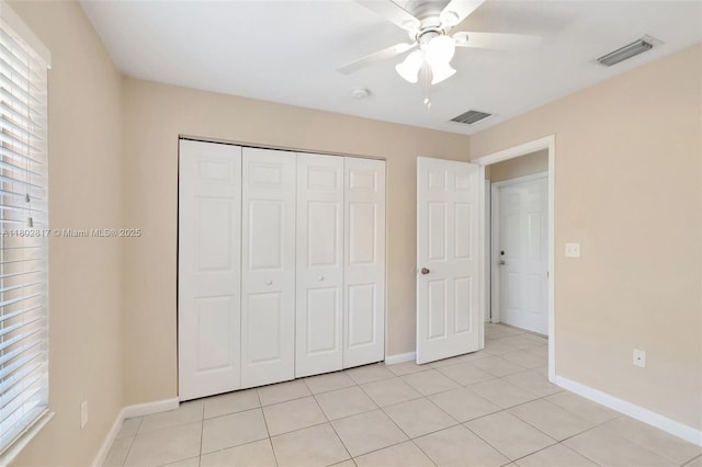 6077 Azalea Cir, West Palm Beach, FL 33415 - unfurnished bedroom with baseboards, light tile patterned floors, a closet, and ceiling fan