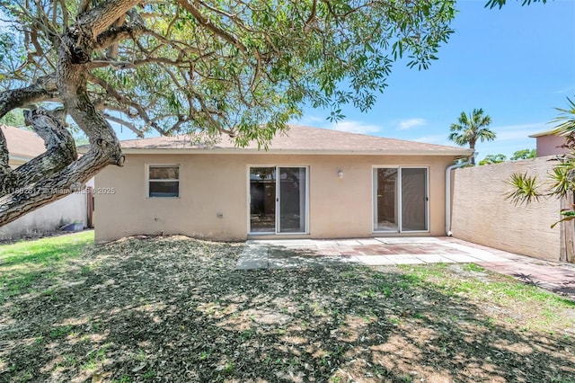 6077 Azalea Cir, West Palm Beach, FL 33415 - rear view of house with stucco siding and a patio