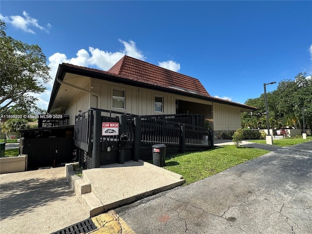 601 Ives Dairy Rd Unit 401-8, Miami, FL 33179 - view of side of home with board and batten siding and a gate
