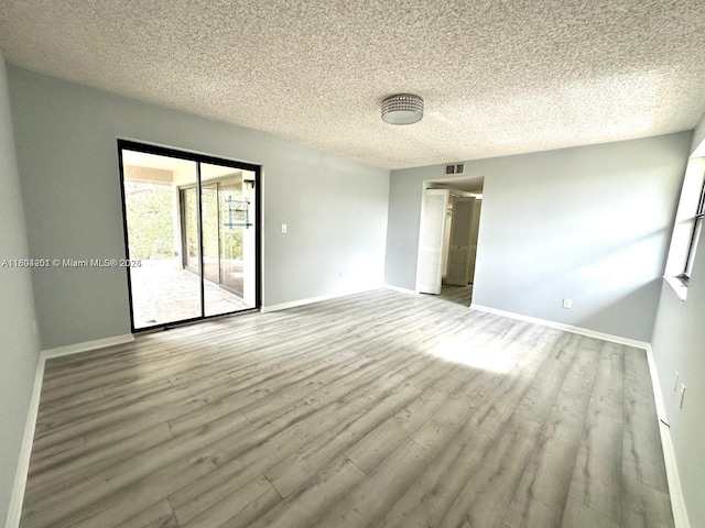 601 Ives Dairy Rd Unit 401-8, Miami, FL 33179 - unfurnished room with wood finished floors, a textured ceiling, and baseboards