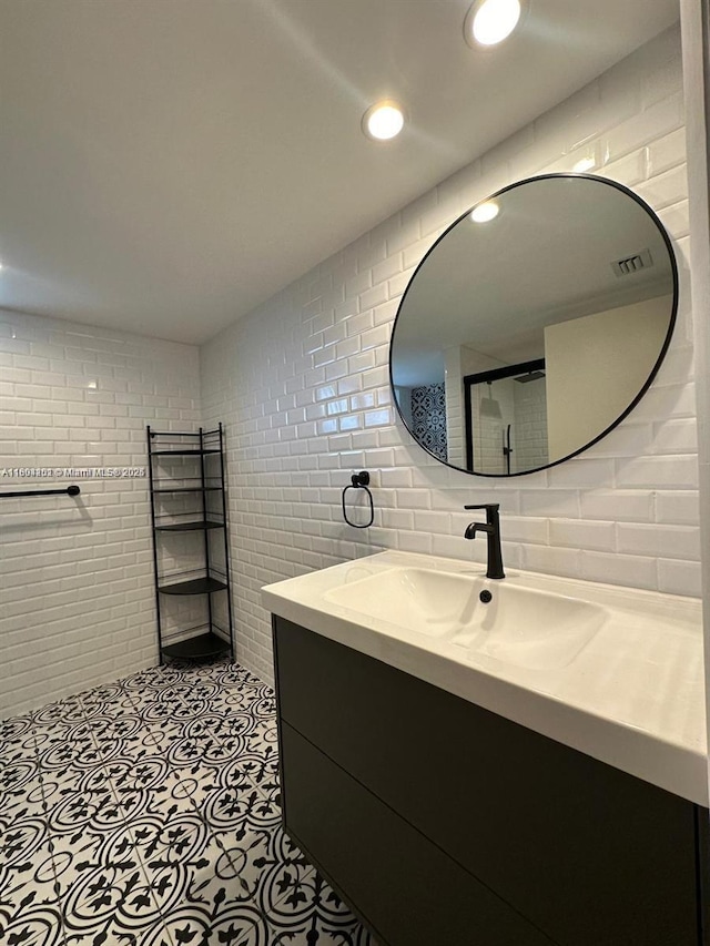 601 Ives Dairy Rd Unit 401-8, Miami, FL 33179 - bathroom featuring a walk in shower, vanity, tile walls, tile patterned flooring, and tasteful backsplash