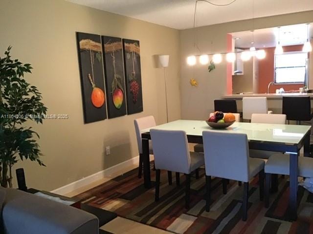 16141 Blatt Blvd Unit 311, Weston, FL 33326 - dining space featuring baseboards and wood finished floors
