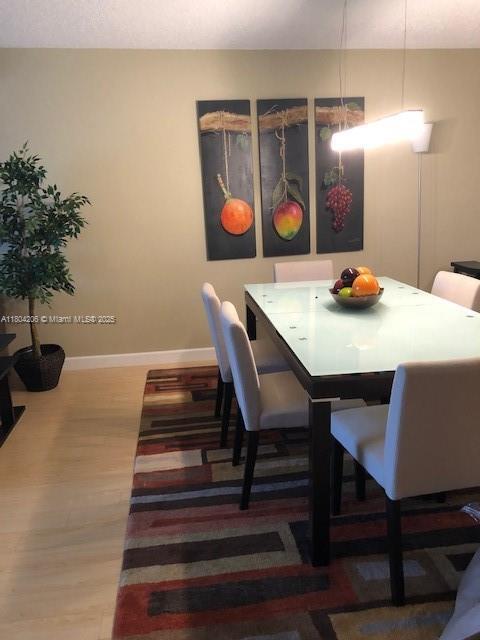 16141 Blatt Blvd Unit 311, Weston, FL 33326 - dining area with baseboards and wood finished floors