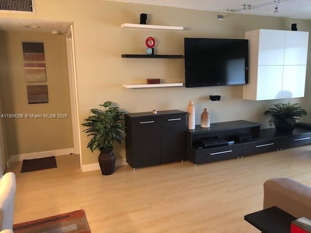 16141 Blatt Blvd Unit 311, Weston, FL 33326 - living area featuring light wood-type flooring and baseboards