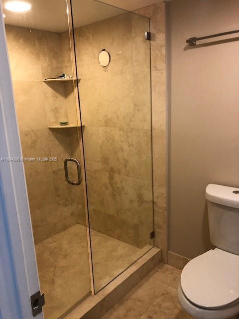 16141 Blatt Blvd Unit 311, Weston, FL 33326 - full bath with a shower stall, toilet, and tile patterned floors