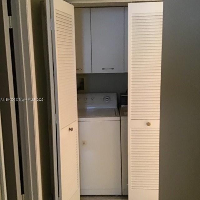 16141 Blatt Blvd Unit 311, Weston, FL 33326 - laundry area with cabinet space and washing machine and clothes dryer