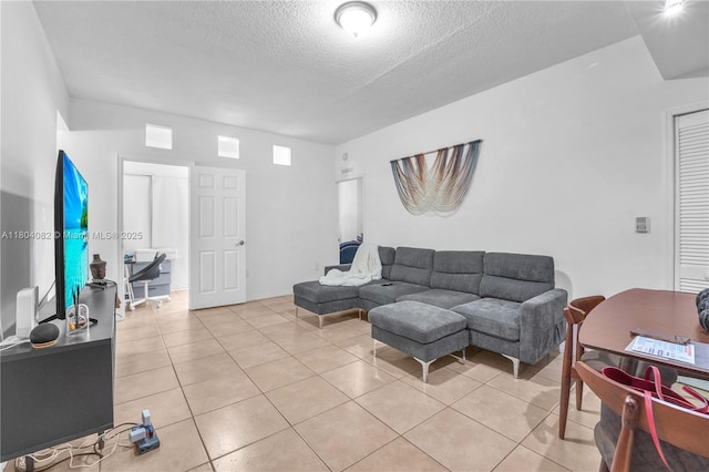 5271 SW 8th St Unit 311, Miami, FL 33134 - living area featuring a textured ceiling and light tile patterned flooring