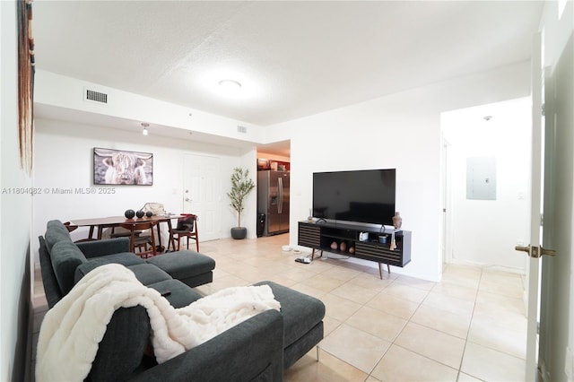 5271 SW 8th St Unit 311, Miami, FL 33134 - living room featuring electric panel, light tile patterned floors, and a textured ceiling