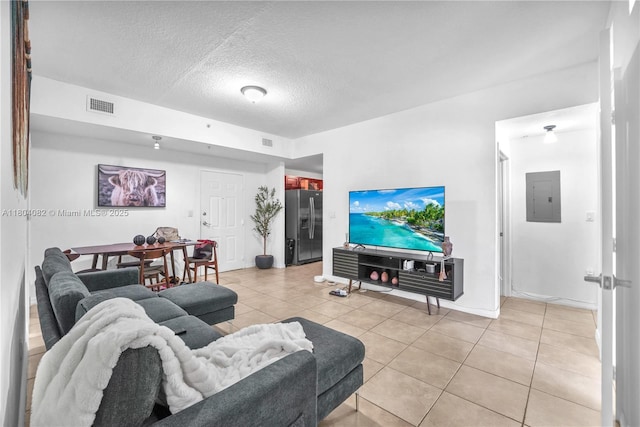 5271 SW 8th St Unit 311, Miami, FL 33134 - living room featuring electric panel, light tile patterned floors, a textured ceiling, and baseboards