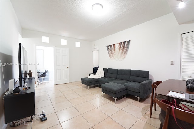 5271 SW 8th St Unit 311, Miami, FL 33134 - living area with light tile patterned flooring and a textured ceiling