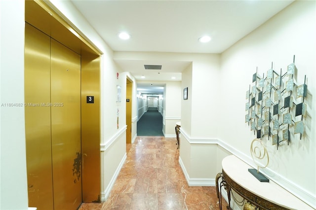 5271 SW 8th St Unit 311, Miami, FL 33134 - hall with elevator, recessed lighting, and light stone finish flooring