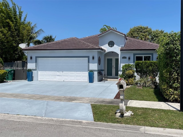 17201 SW 143rd Ct, Miami, FL 33177 - view of front of house featuring french doors, a garage, concrete driveway, and stucco siding