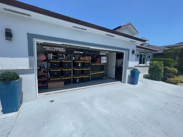 17201 SW 143rd Ct, Miami, FL 33177 - view of side of property with mail area, stucco siding, and an attached garage