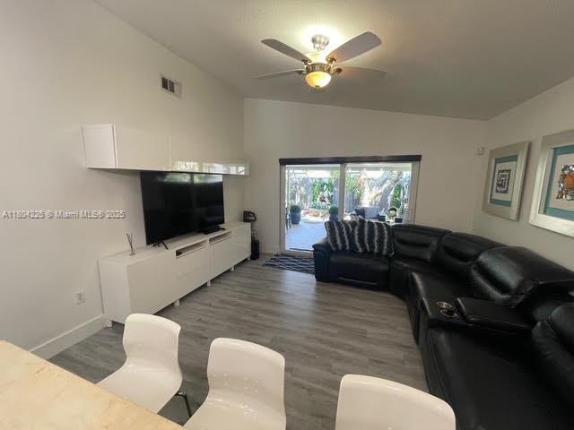 17201 SW 143rd Ct, Miami, FL 33177 - living area with a ceiling fan, wood finished floors, baseboards, and vaulted ceiling