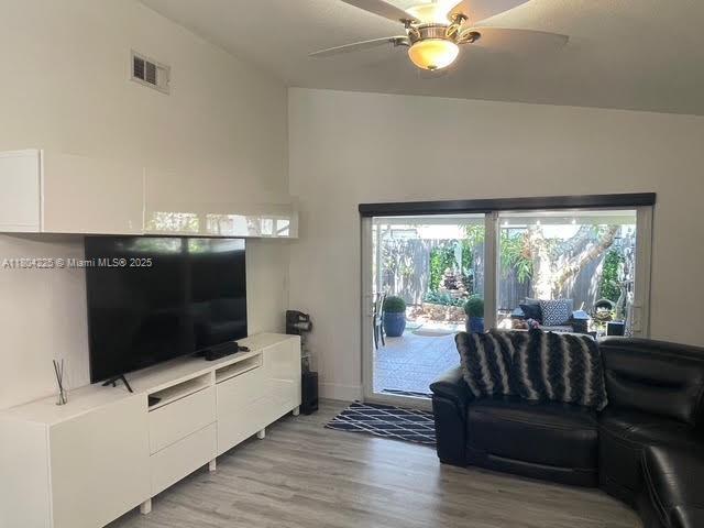 17201 SW 143rd Ct, Miami, FL 33177 - living area with a ceiling fan, light wood-style flooring, and baseboards