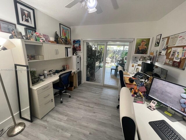 17201 SW 143rd Ct, Miami, FL 33177 - home office featuring light wood-type flooring, a ceiling fan, a textured ceiling, and built in desk