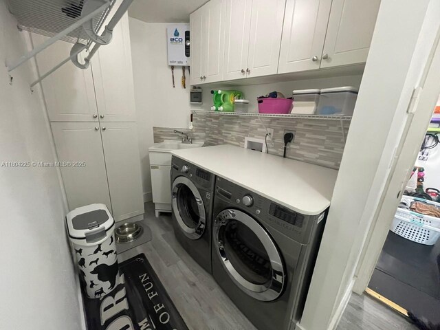 17201 SW 143rd Ct, Miami, FL 33177 - washroom featuring cabinet space, separate washer and dryer, and wood finished floors