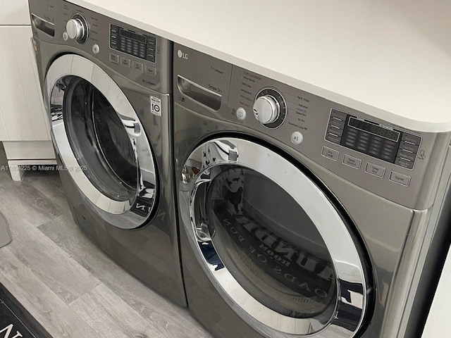 17201 SW 143rd Ct, Miami, FL 33177 - laundry room featuring washer and dryer and wood finished floors